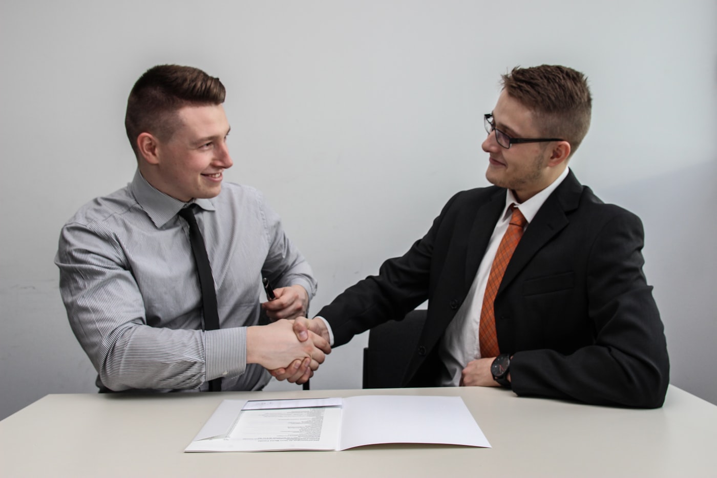 An advisor and a client talking across a table during a friendly meeting