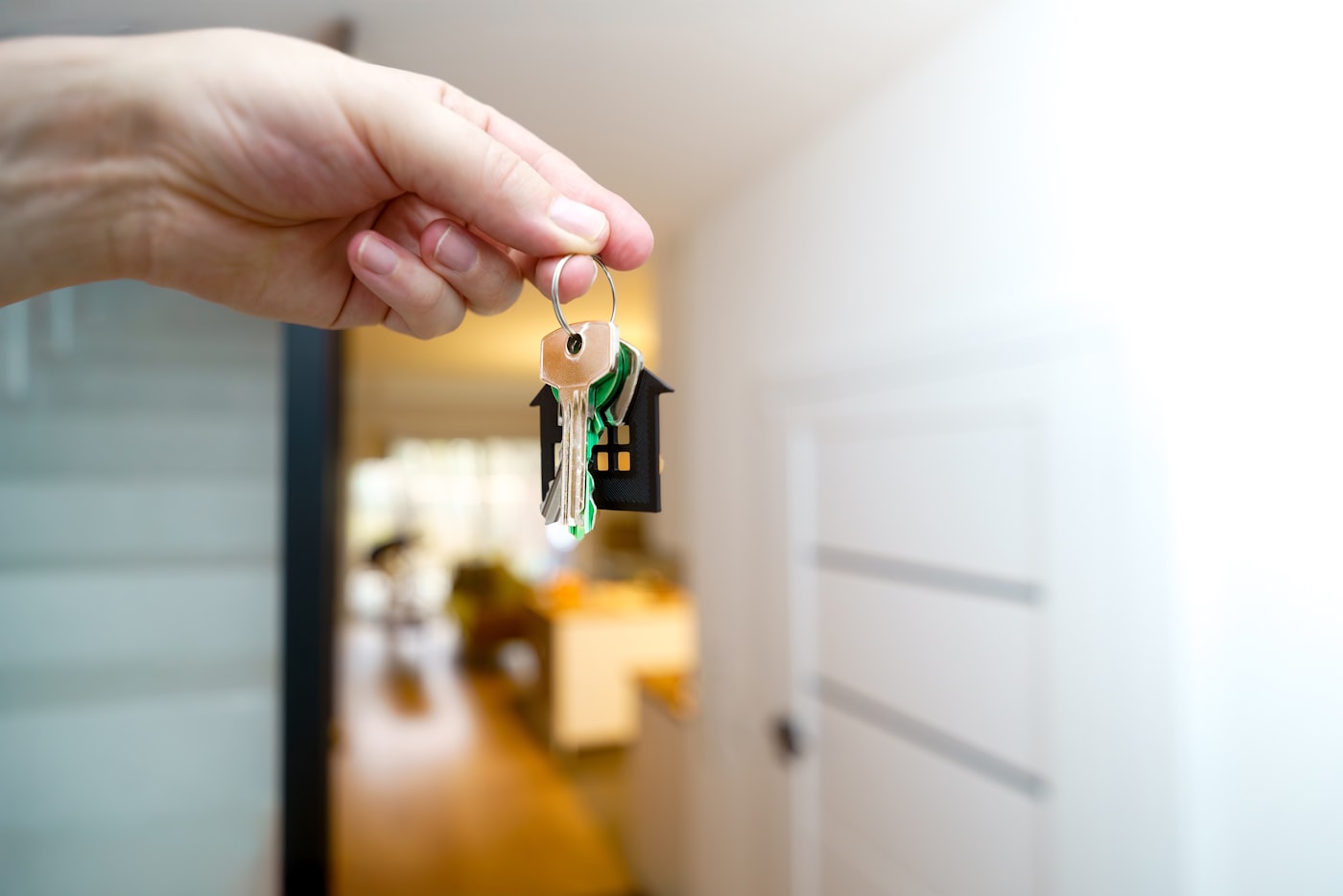 A hand holding the keys to a newly purchased home